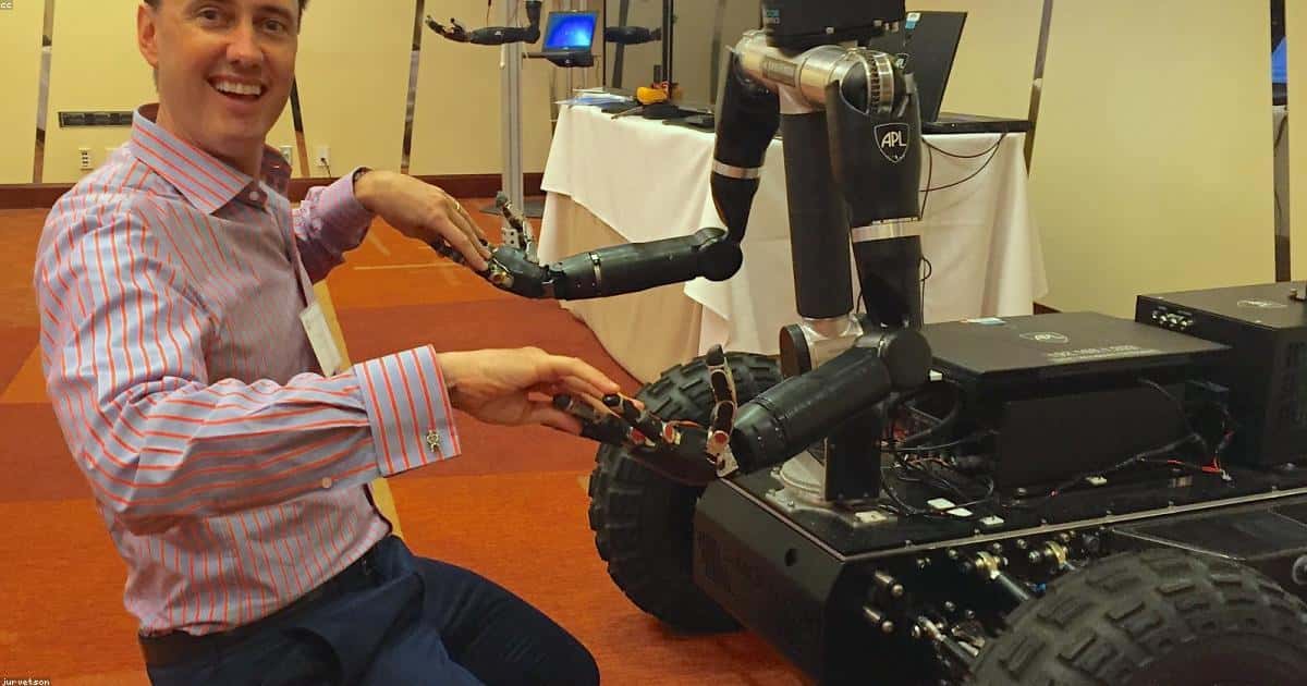 Man and robot shaking hands representing human-AI collaboration