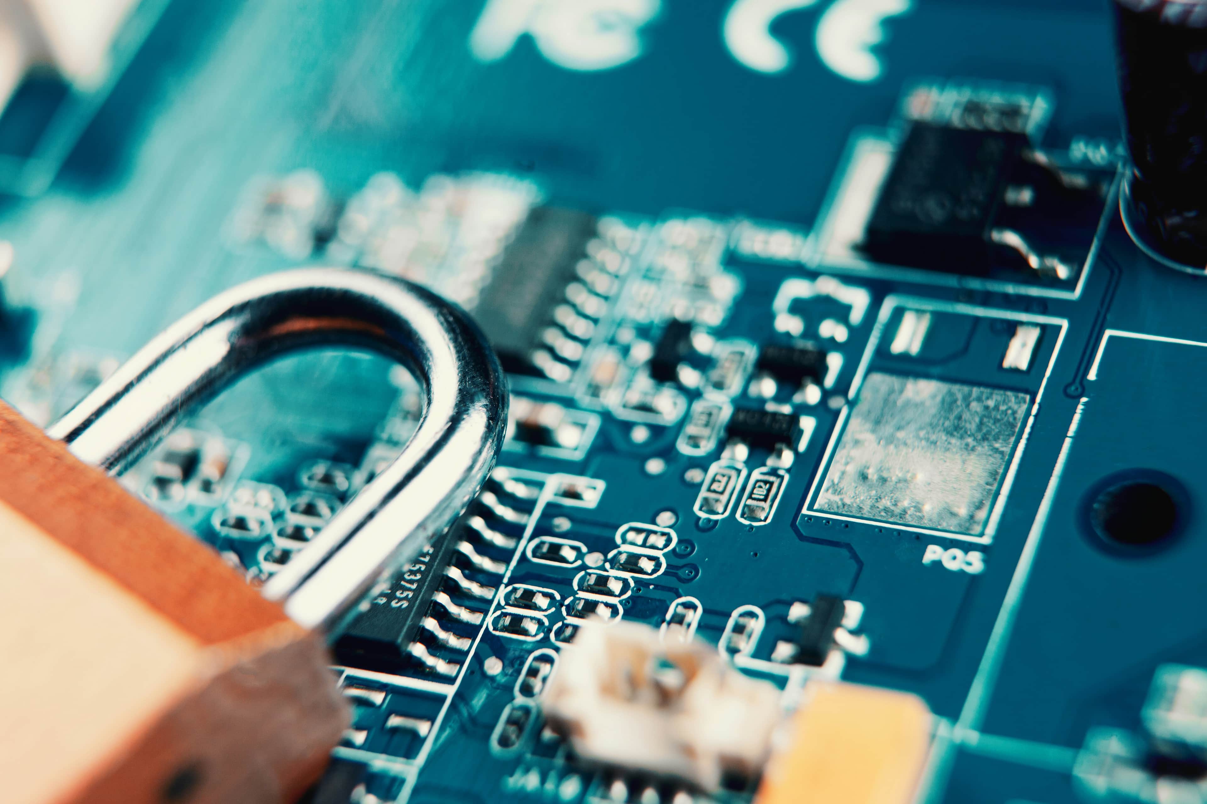 A padlock on top of a circuit board representing digital security