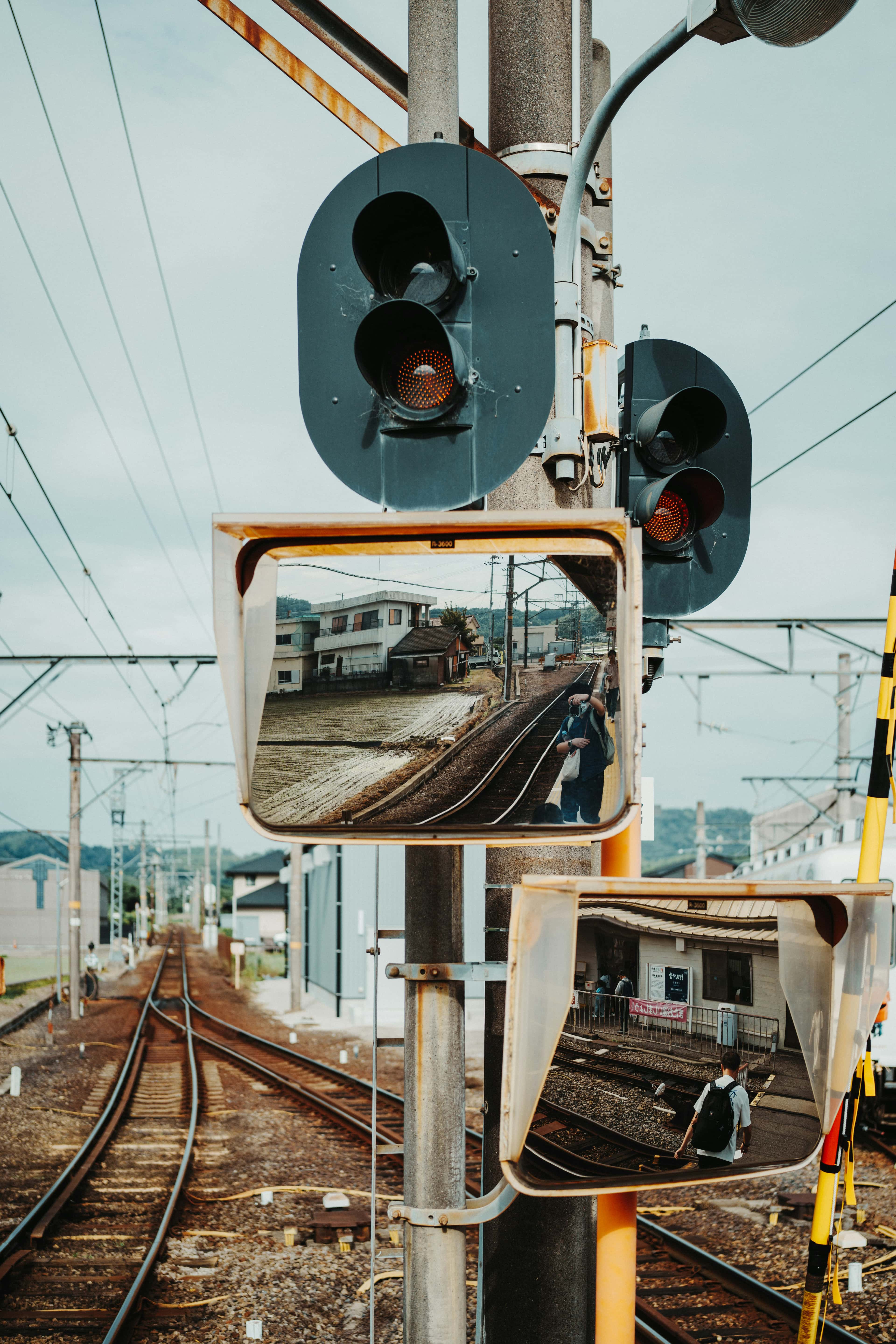 Train tracks reflected in safety mirrors with signals