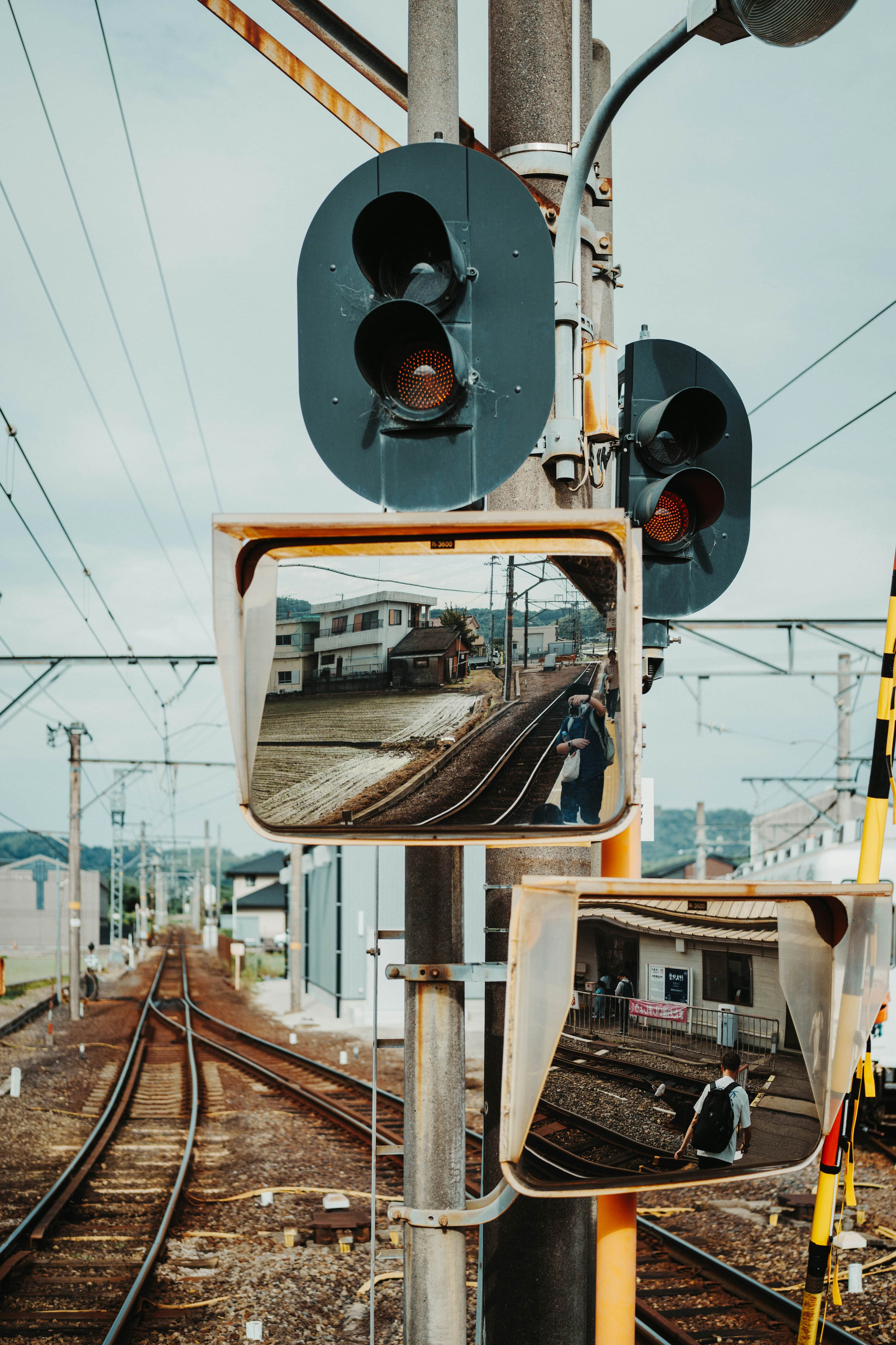 Train tracks reflected in safety mirrors with signals