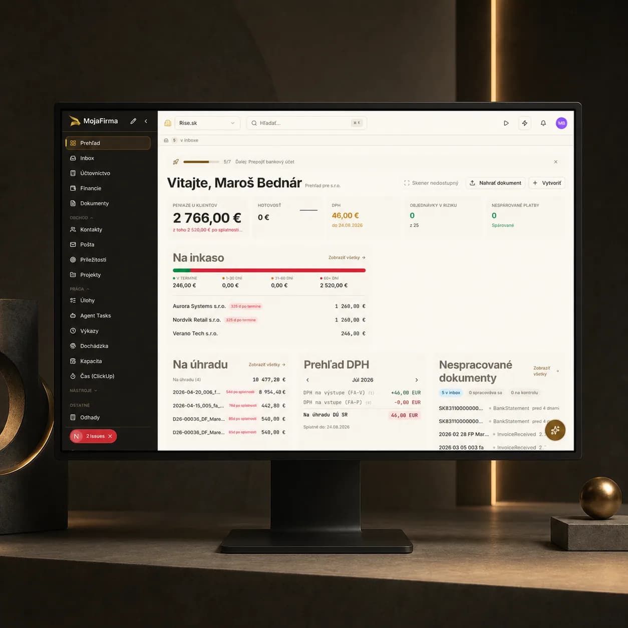 MojaFirma dashboard on a standalone monitor in a dark studio
