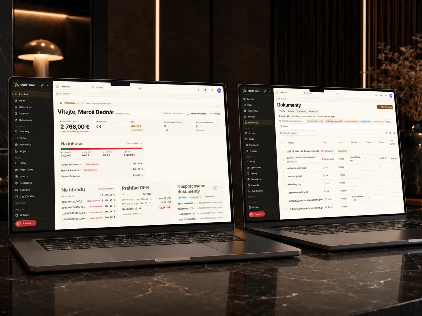 MojaFirma dashboard and documents on two laptops